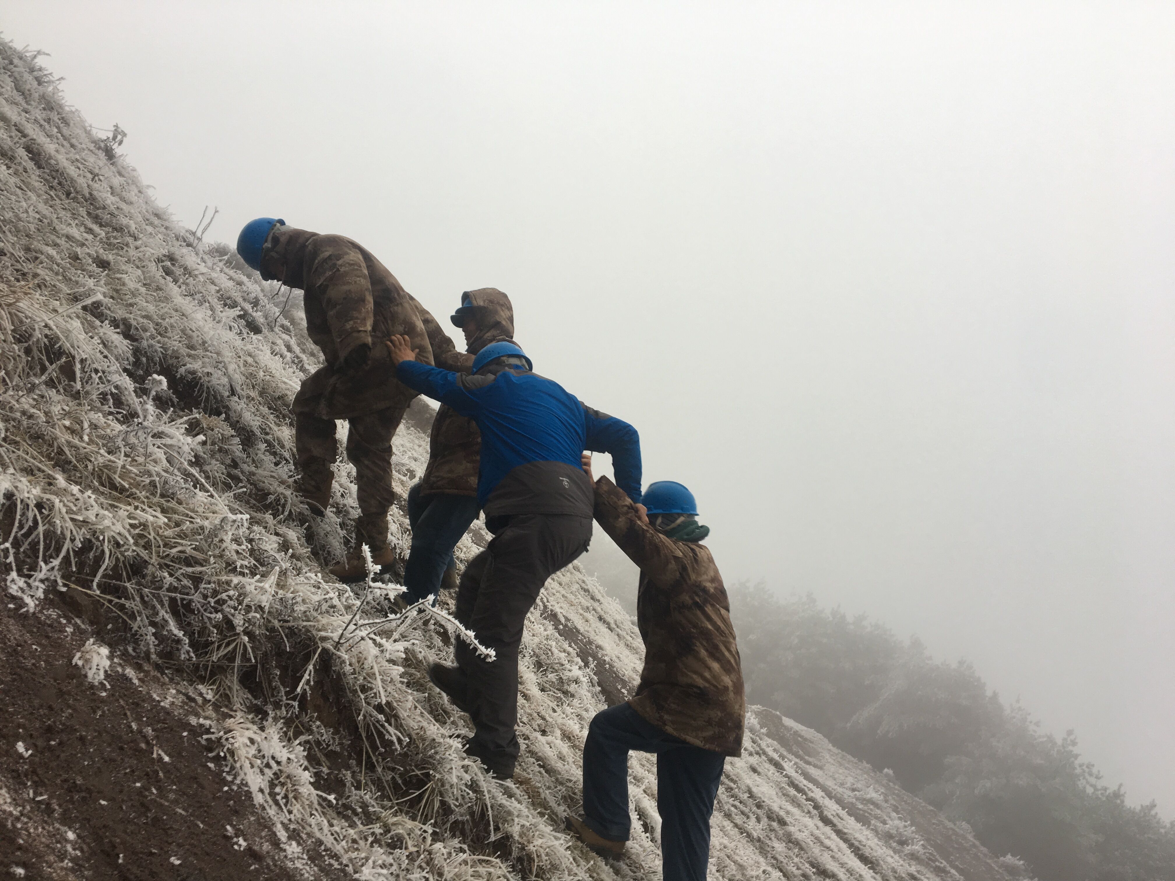 互相攙扶，勇登高峰。（李健攝）